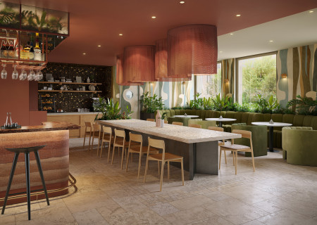 Ein langer Tisch und gemütliche Sitzecken im Restaurant des neuen Hotel Schani City