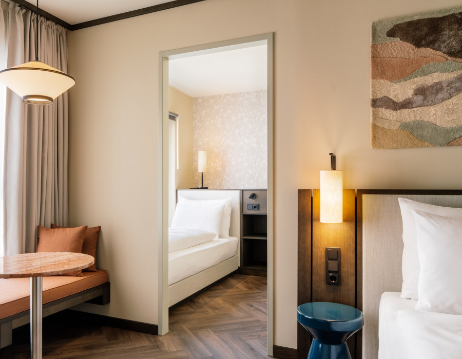Double bed and single bed in a hotel room for the whole family