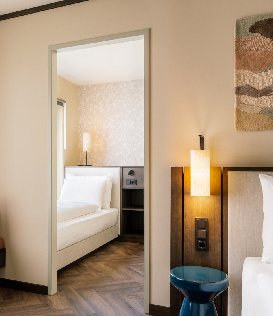 Double bed and single bed in a hotel room for three people 