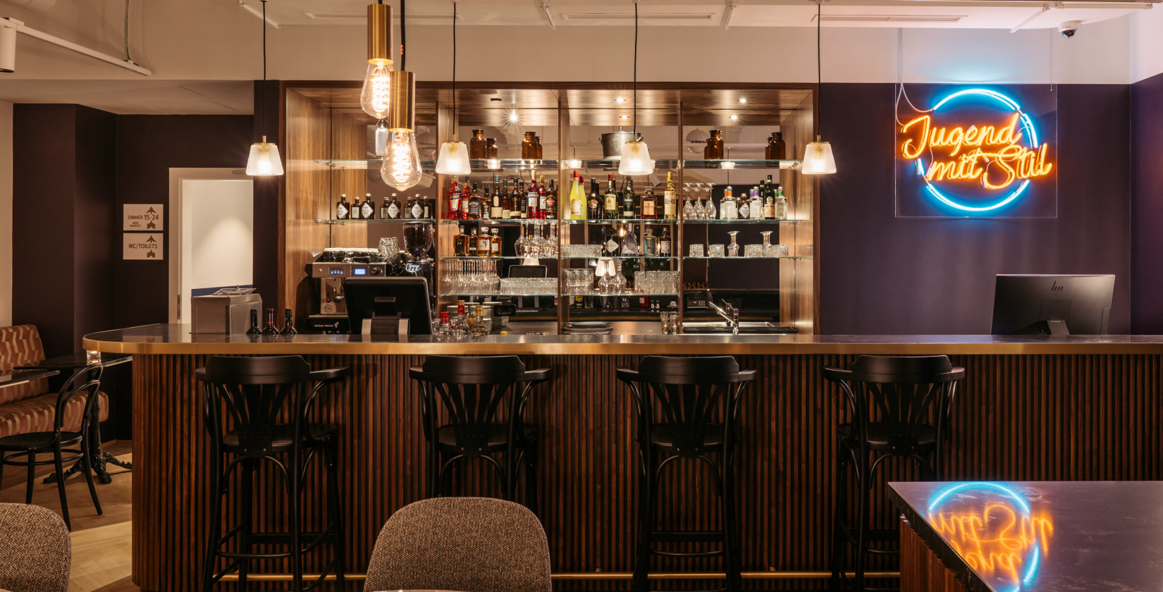 Bar where four bar stools stand at the counter