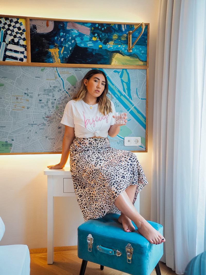 Woman sitting at a desk in a room at Hotel Schani Salon