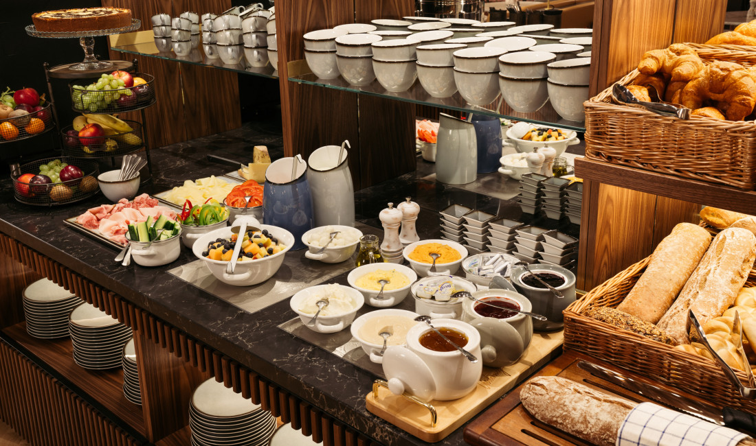 Breakfast buffet with bread, jams and vegetables at Hotel Schani Salon