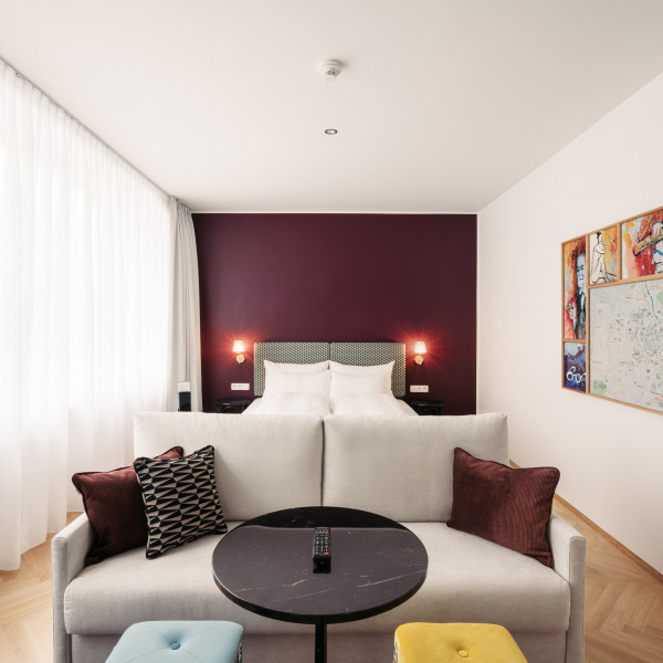 Bed and sofa in room Smart Atelier in Hotel Schani Salon 