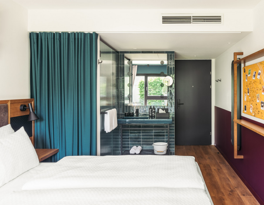 Open bathroom with a rainshower and a washstand at Hotel Schani UNO City