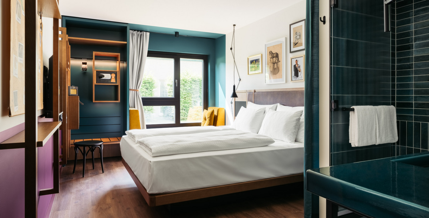 Bed in a bright Smart Street Room with a large window at Hotel Schani Wien