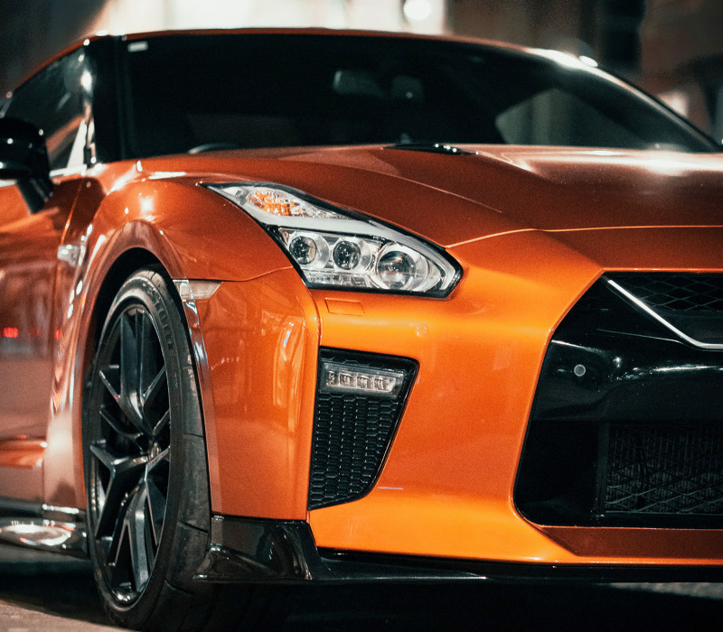 Close-up from below of an orange car