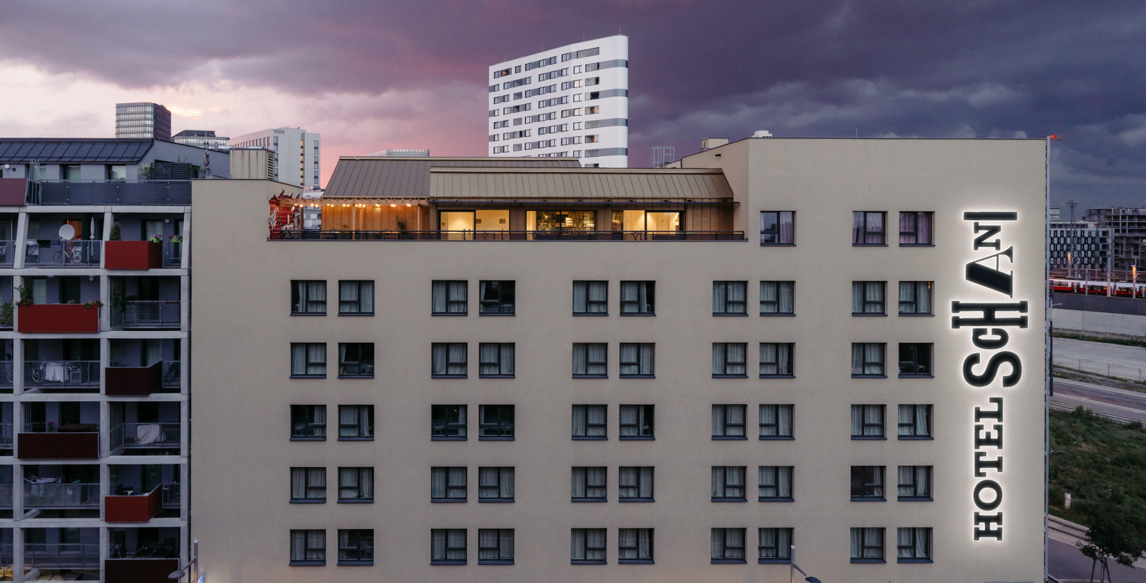 Exterior view of Schani's Rooftop Event Spaces with terrace at sunset