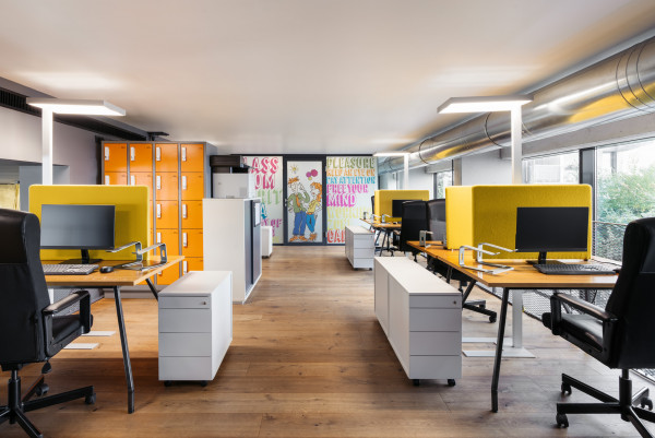 Workstations in the coworking space with Schani's Boardroom