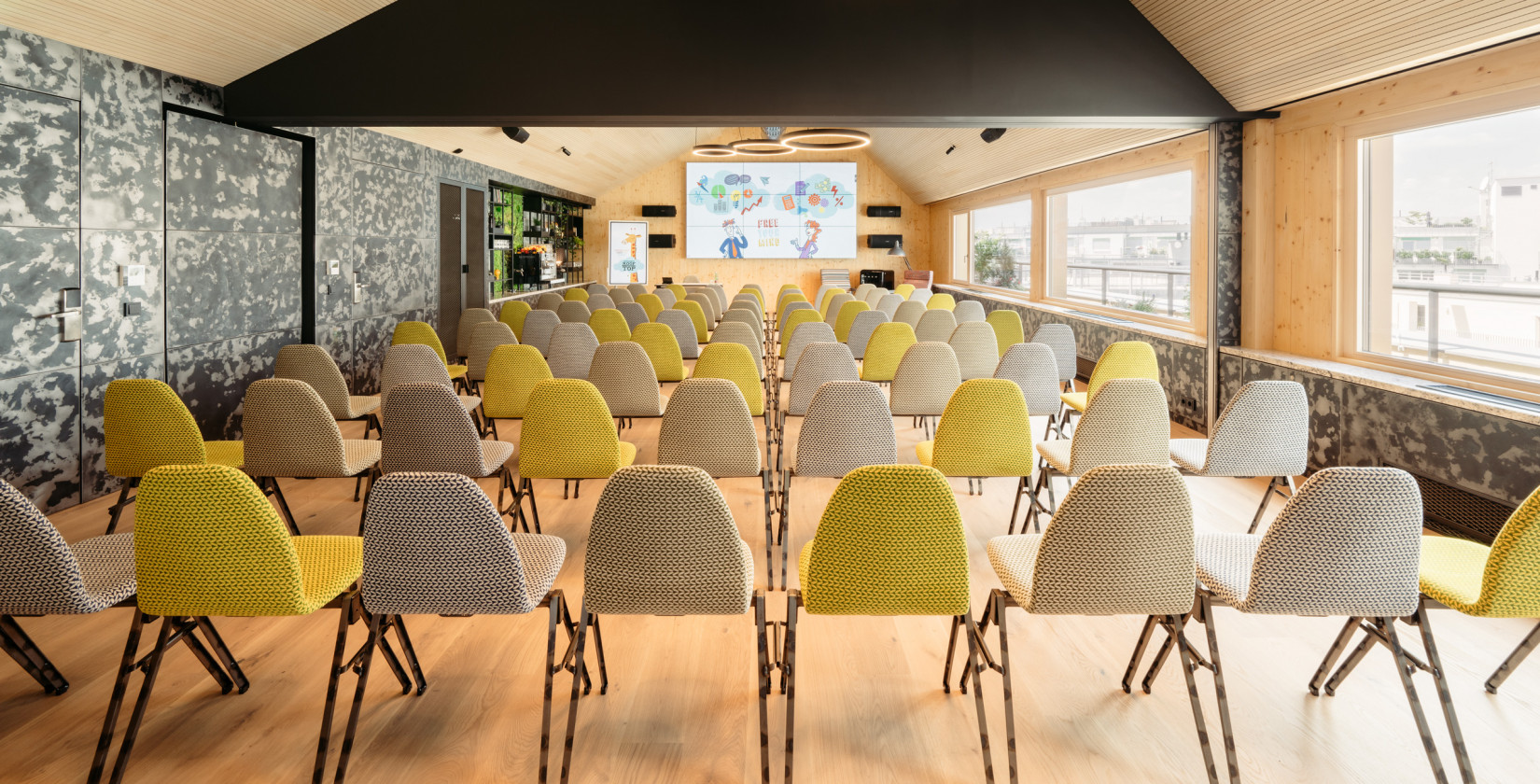 Seminar room with a large screen in the rooftop event space at Hotel Schani Wien