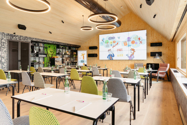 Seminar room with a large screen in the rooftop event space at Hotel Schani Wien