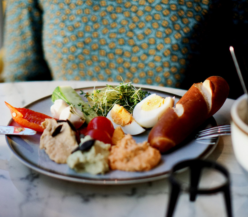 Breakfast plate with bread, spreads, eggs and vegetables