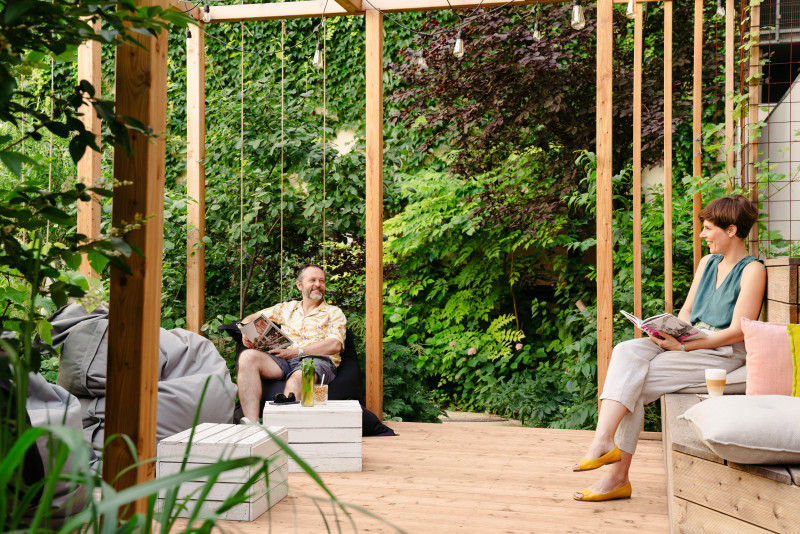 Paar sitzt in Pergola in Schani's Garten