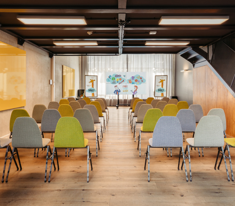 Seated seminar room with large screen 