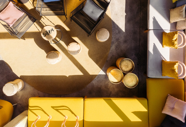 Comfortable seats in the sunny lobby at Hotel Schani Wien from the bird's eye view