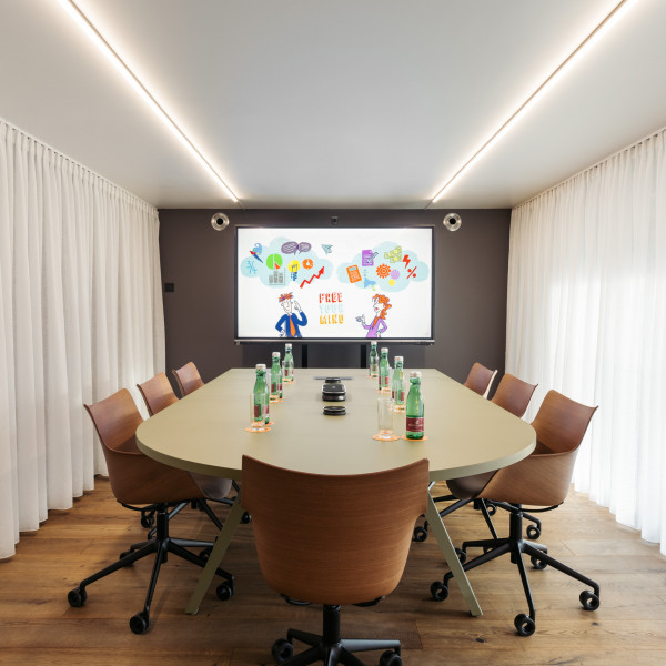 Prepared meeting table in meeting room with space for up to 8 people