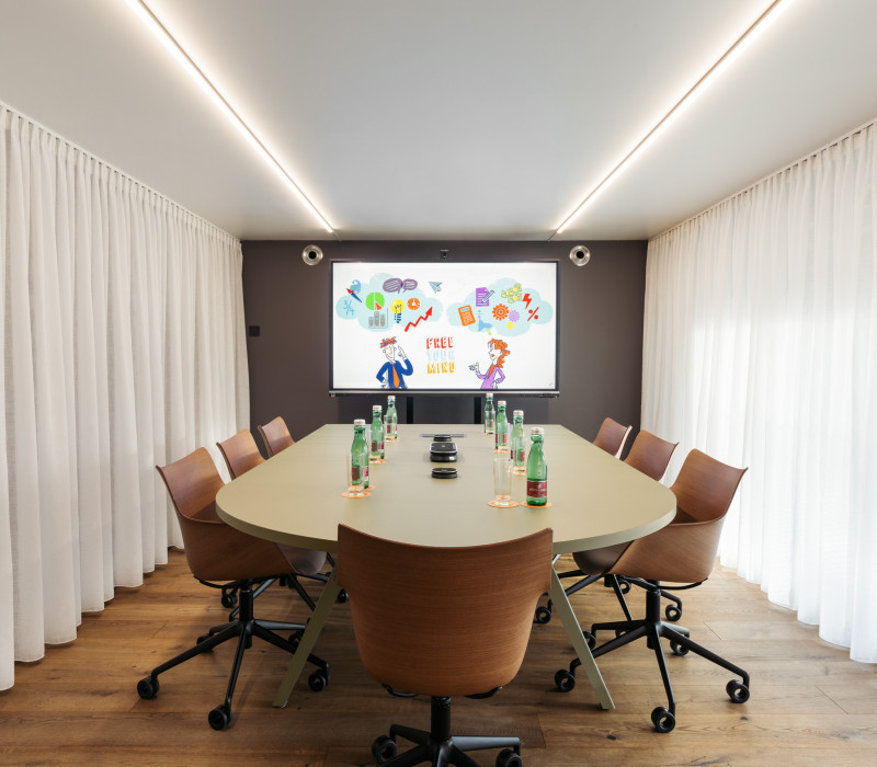 Prepared meeting table in meeting room with enough space for up to 8 people