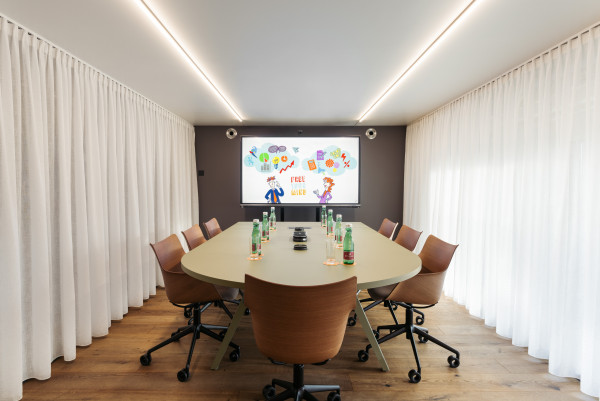 Prepared meeting table in meeting room with space for up to 8 people