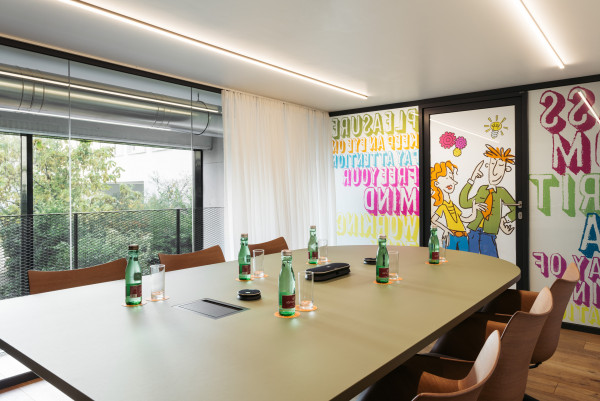 Prepared meeting table in meeting room with view of the garden