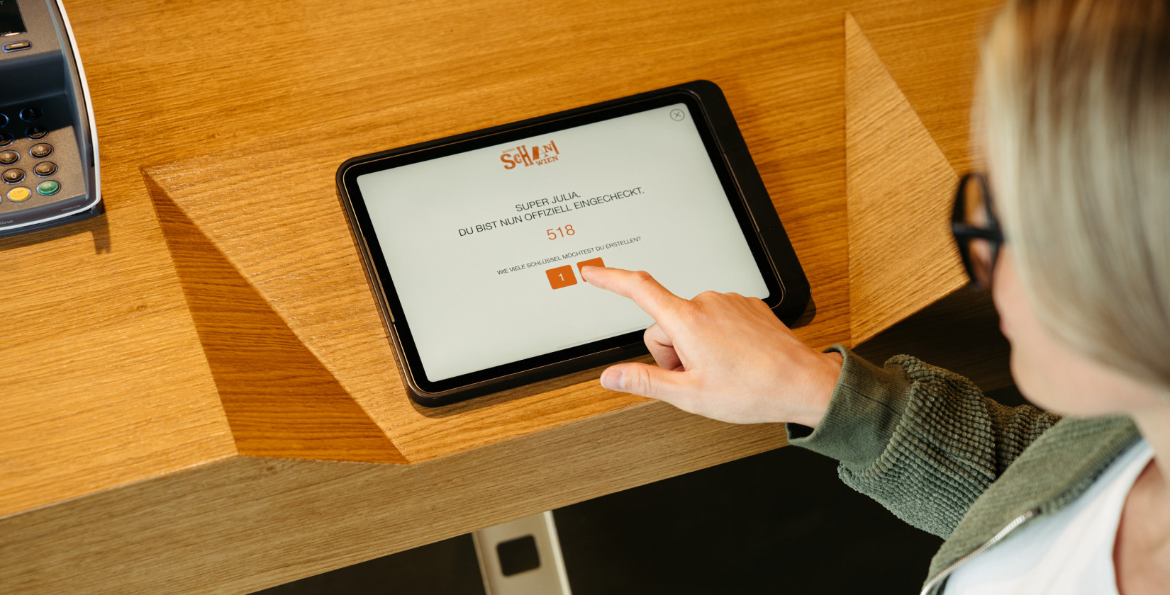 Woman at self check-in in the lobby at Hotel Schani Wien 