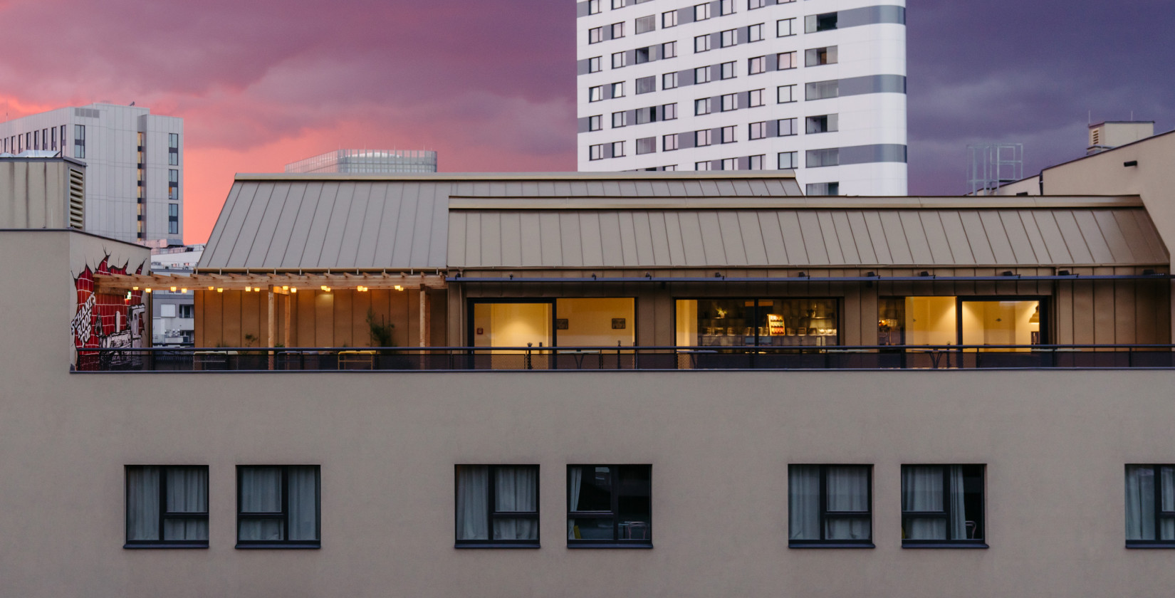 Exterior view of Schani's Rooftop Event Spaces with terrace at sunset