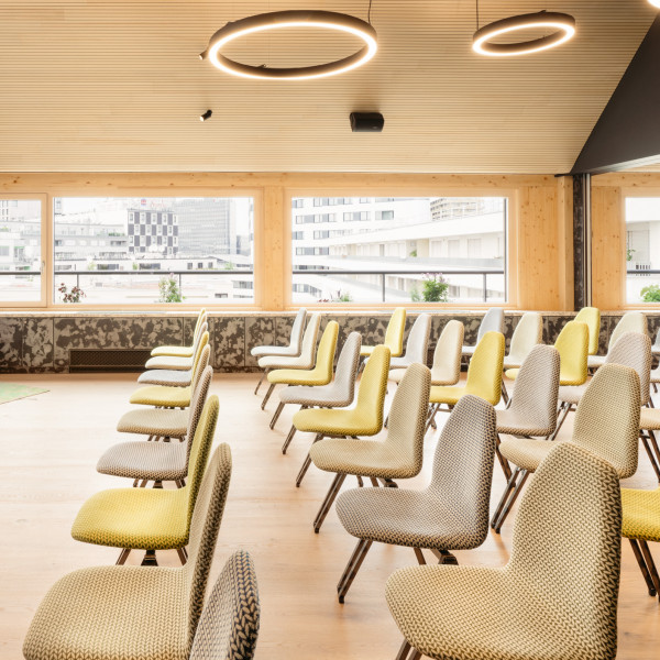 Seminar room with a large screen in the rooftop event space at Hotel Schani Wien