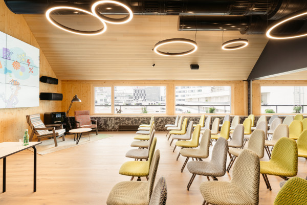 Seminar room with a large screen in the rooftop event space at Hotel Schani Wien