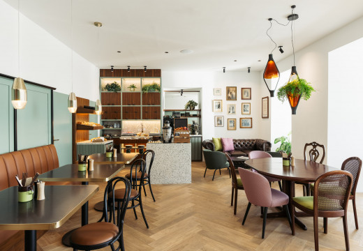 Breakfast room with buffet in the background and numerous chairs and tables in the room