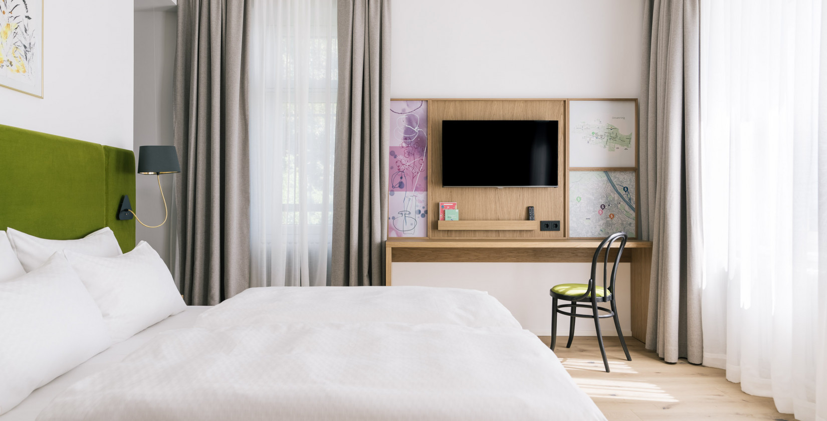 TV, bed and workplace in a Smart Double Room at Bio-Hotel Schani Wienblick