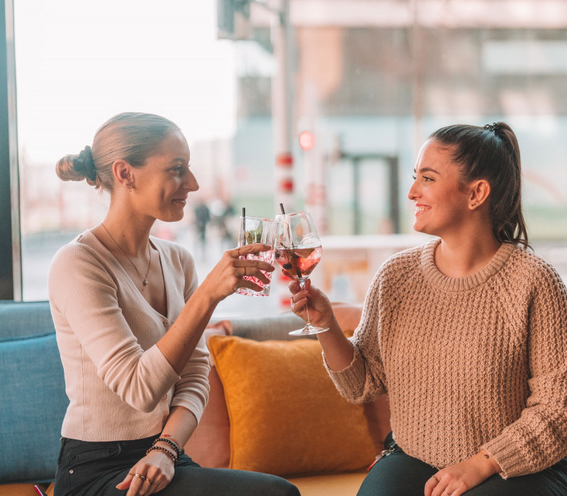 Two women drinking cocktails in the hotel bar in Vienna