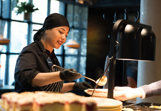 Eine Köchin beim Teller Anrichten