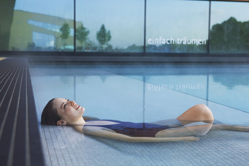 Woman relaxing in a pool at Therme Wien