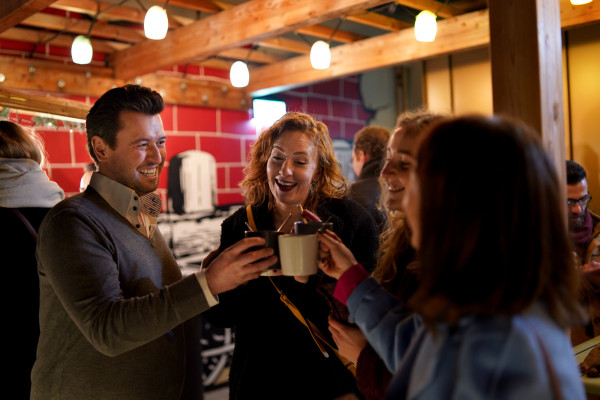 Guests at a christmas party at Hotel Schani Wien drinking punch